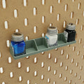 Testors Paint Rack in Muted Green on IKEA SKADIS pegboard with blue, white, and black paint.