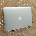 Laptop Organizer hooks in Charcoal Black on IKEA SKADIS pegboard with MacBook Air laptop.