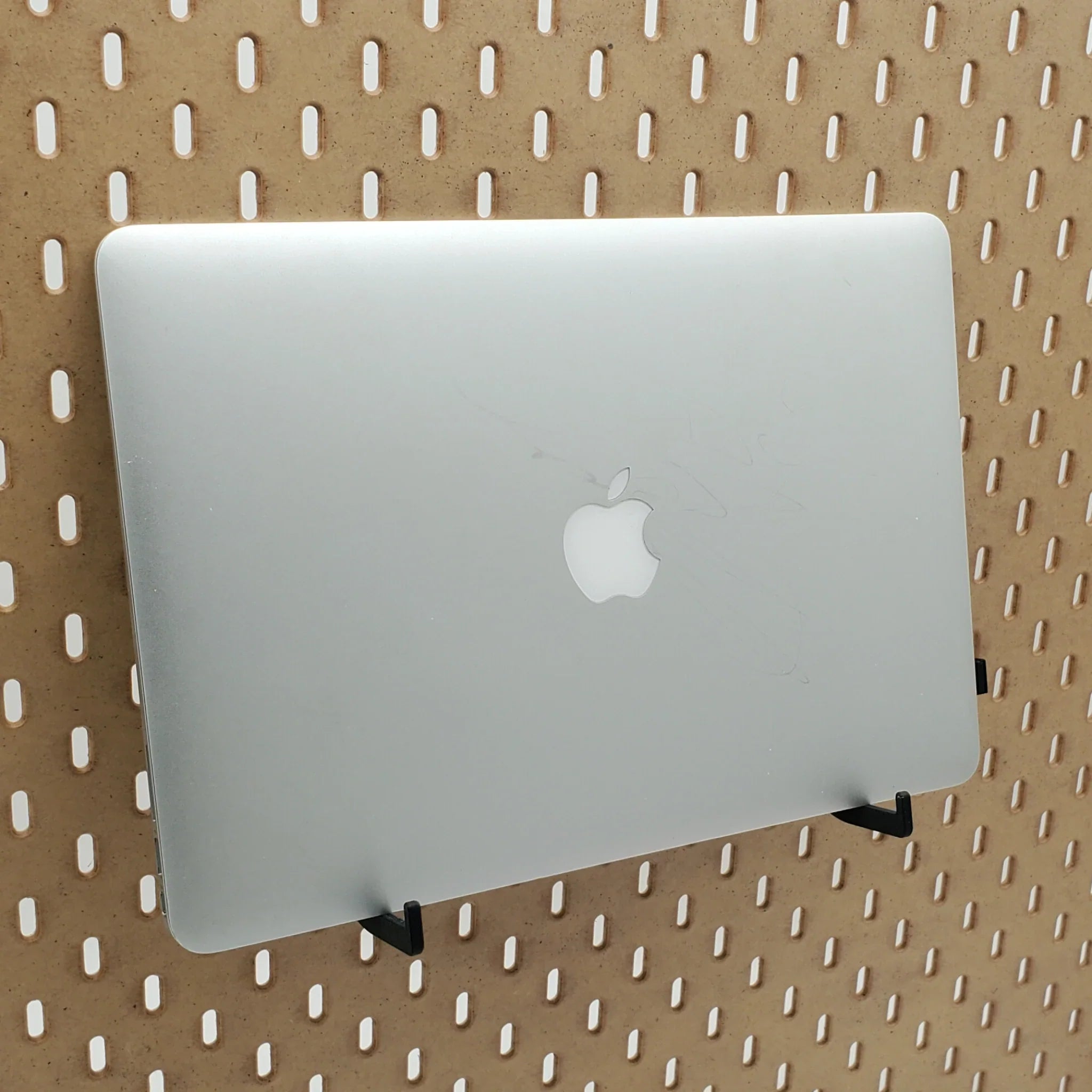 Laptop Organizer hooks in Charcoal Black on IKEA SKADIS pegboard with MacBook Air laptop.