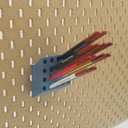 Pencil Organizer in Muted Blue on IKEA SKADIS pegboard with colored pencils.