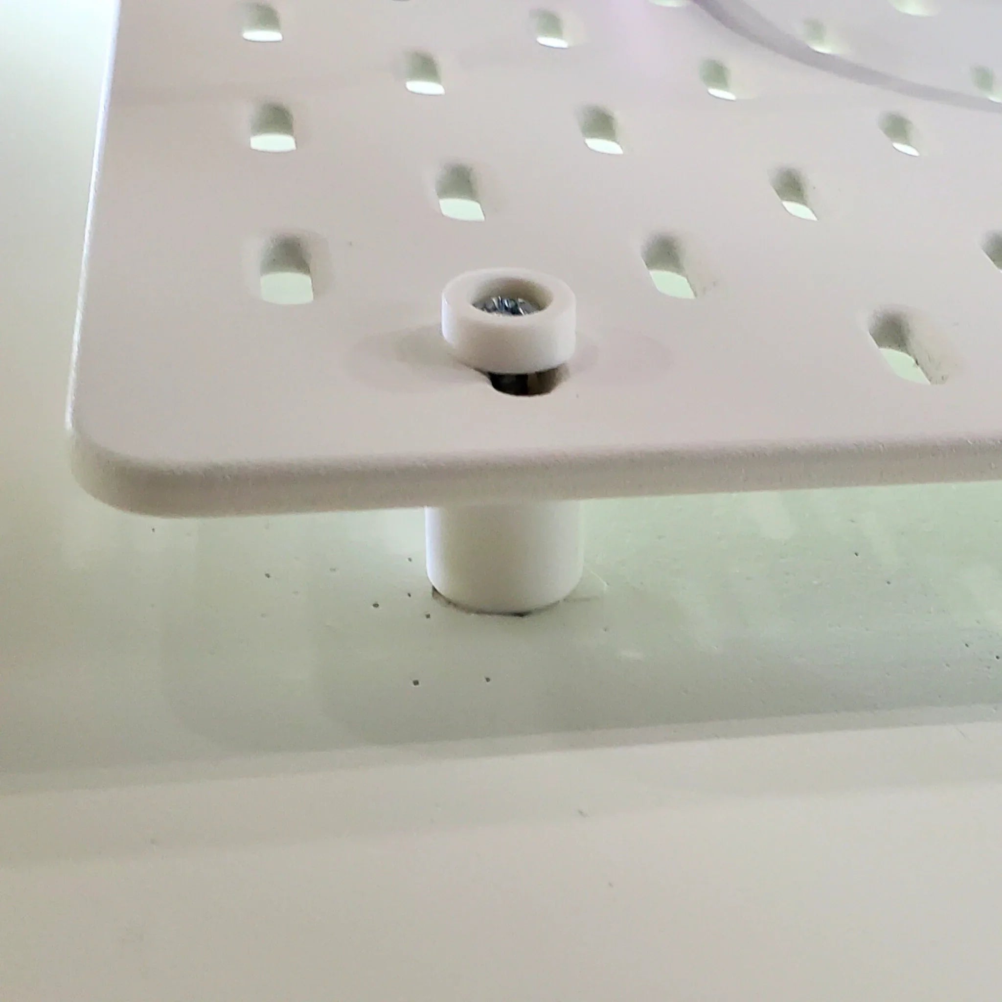 Detail of Mounting Hardware Kit in Cotton White on IKEA SKADIS pegboard.
