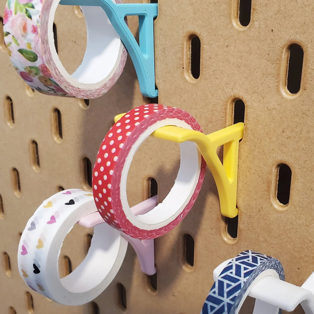 Washi Tape Storage Hooks in Savannah Yellow, Light Pink, Teal, and Cotton White on IKEA SKADIS pegboard with Washi tape.