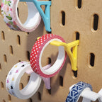 Washi Tape Storage Hooks in Savannah Yellow, Light Pink, Teal, and Cotton White on IKEA SKADIS pegboard with Washi tape.