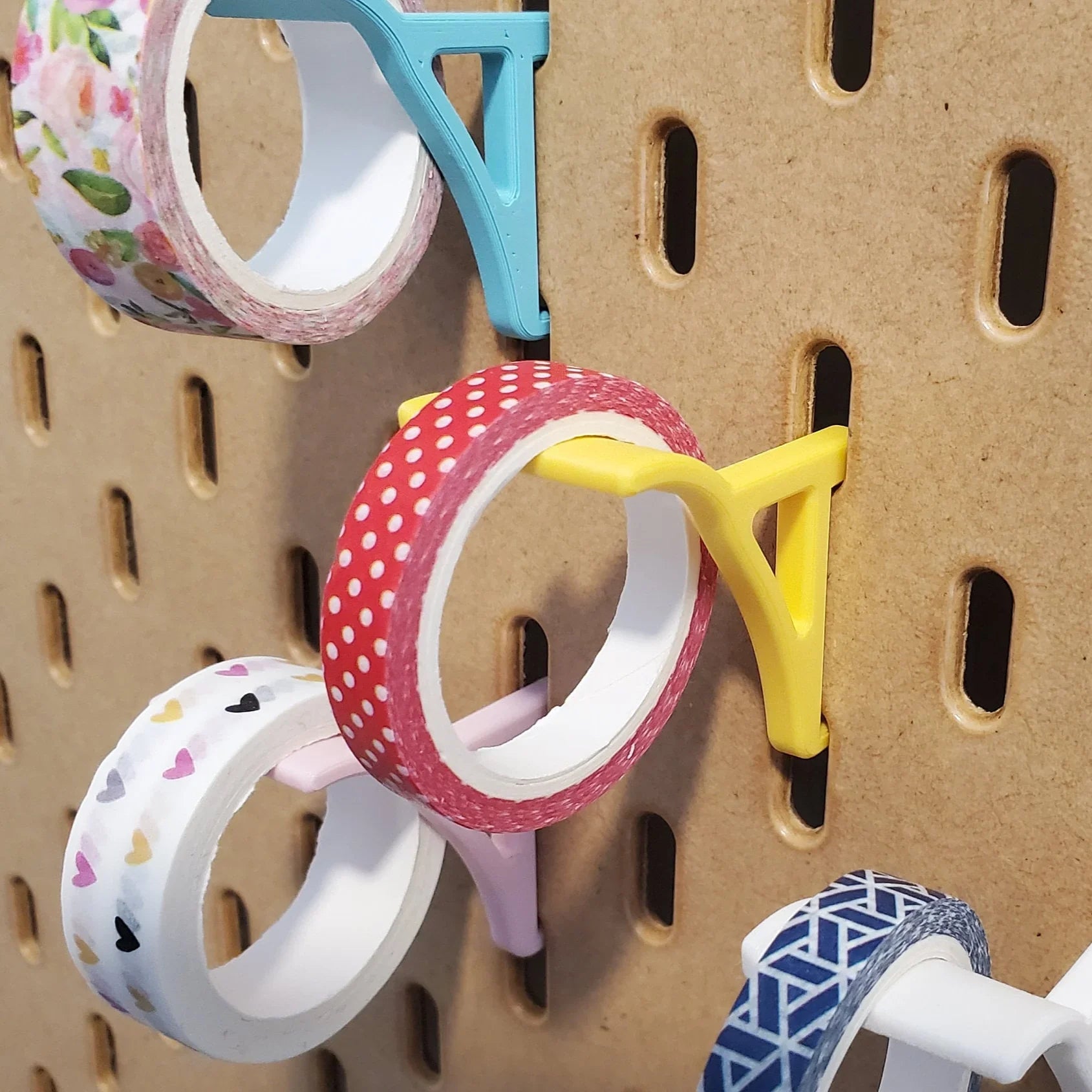 Washi Tape Storage Hooks in Savannah Yellow, Light Pink, Teal, and Cotton White on IKEA SKADIS pegboard with Washi tape.