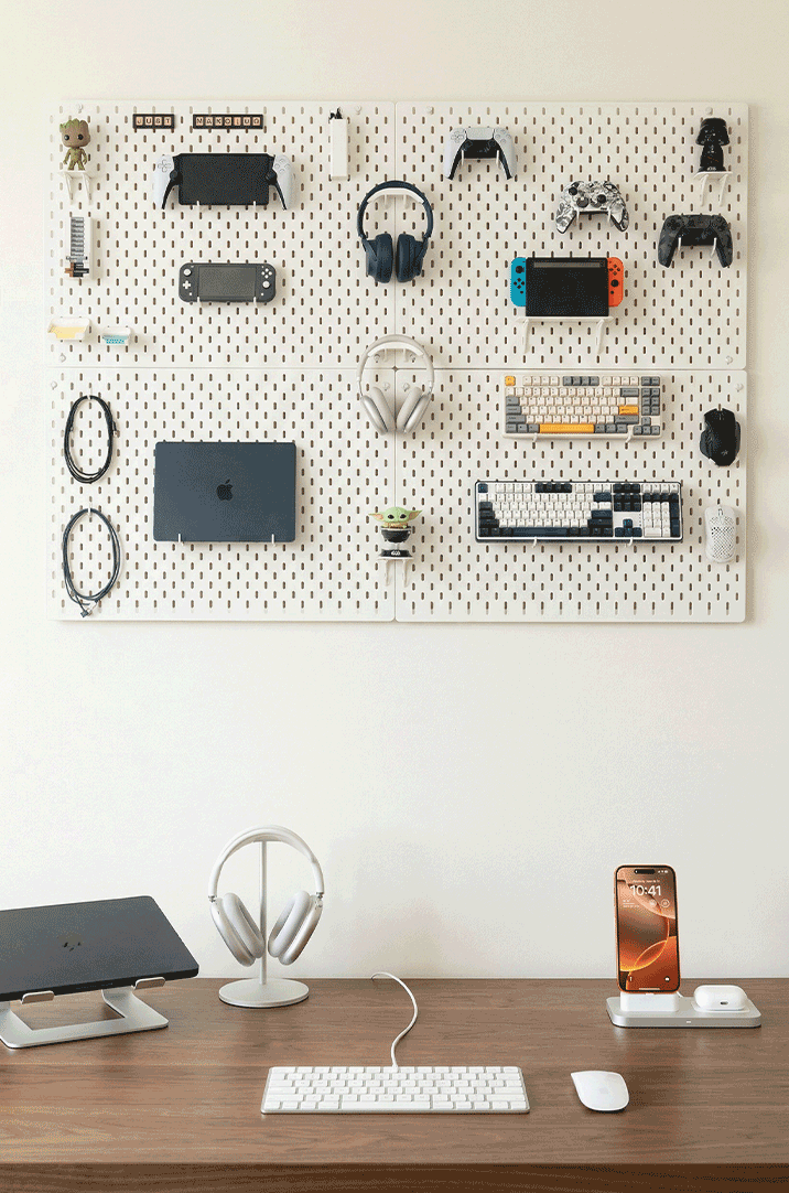 Pegboard with various gaming devices on a desk setup